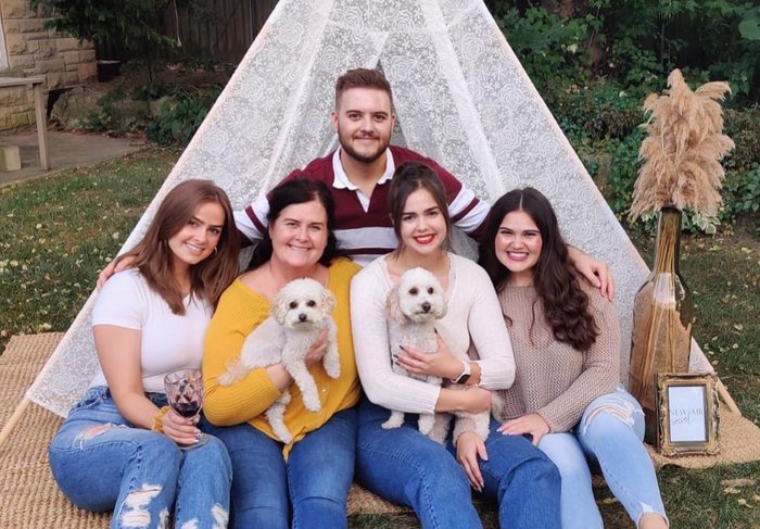 Nicholas with his mom and sisters
