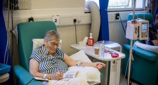 A woman doing a crossword in a day unit