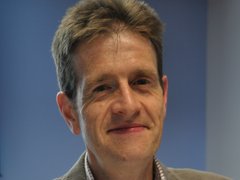 A portrait image of leukemia researcher Anthony Moorman, who is smiling at the camera.