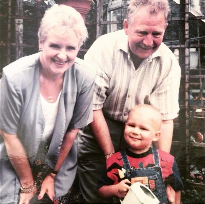 Black and white photo of child with grandparents