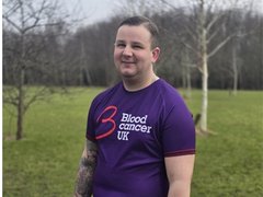 Man in Blood Cancer UK T-shirt smiling at the camera.