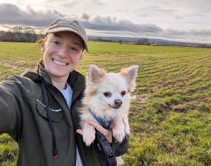 Female taking a selfie holding her dog close to the camera