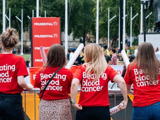 A group of Blood Cancer UK supporters stand at a cheer point at the Prudential RideLondon cycling event.