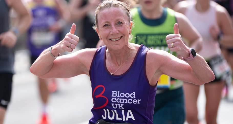Female runner with thumbs up posing for the camera and smiling