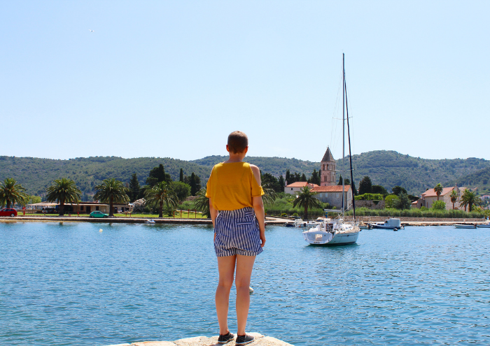 Charlotte looking at a boat on the water