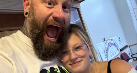 Mark taking a close up selfie whilst hugging Addie