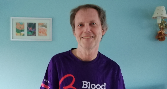 David Lauder wearing a purple branded Blood Cancer UK t-shirt.