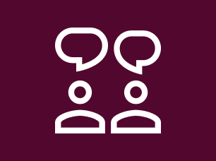 A Blood Cancer UK branded icon in white and maroon of two people with speech bubbles above their head, as if in conversation with one another.