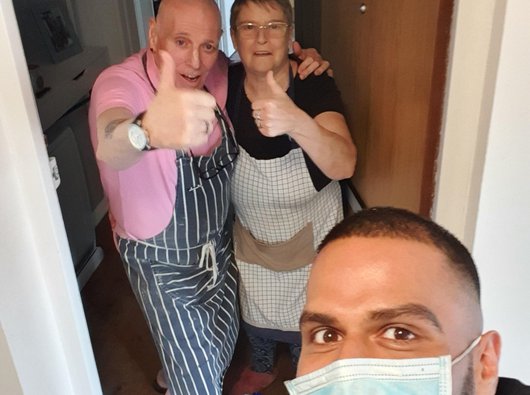 Sunny, a non-Hodgkin lymphoma patient with a mask on delivering food to neighbours during the Covid-19 pandemic.