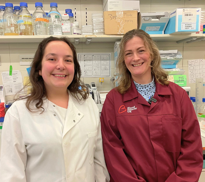 Dr Beth Payne & Dr Alexandra Lubin stood in the lab wearing their lab coats.