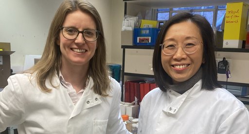 Dr Tracey Chan and Dr Jen Heaney stood in the lab together smiling.