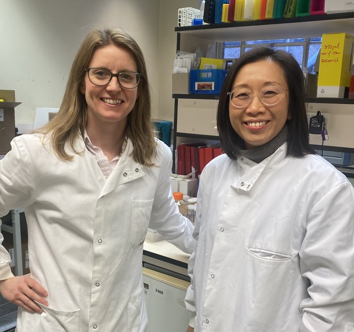 Dr Tracey Chan and Dr Jen Heaney stood in the lab together smiling.