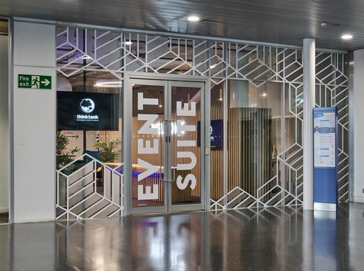 An image showing the glass door entrance to the Thinktank Event Suite located on the third floor of Millenium Point