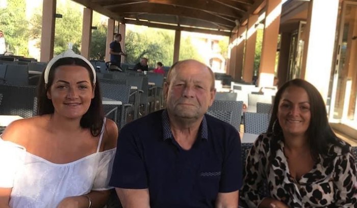 A daughter, father and mother sit together in an empty cafe.