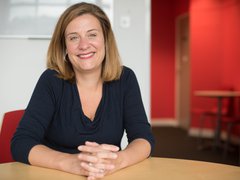 CEO Gemma Peters smiling at her desk