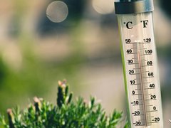 A thermometer rises on a hot day