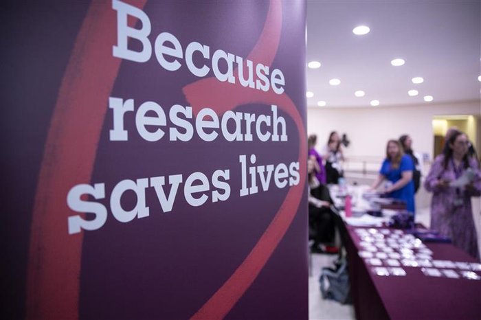 An image of a Research Saves Lives pull up banner at an event registration desk