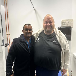 Support nurse and Joe livign with blood cancer standing next to each other