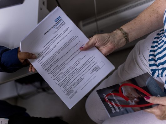 Mock PIS sheet being handed to a patient