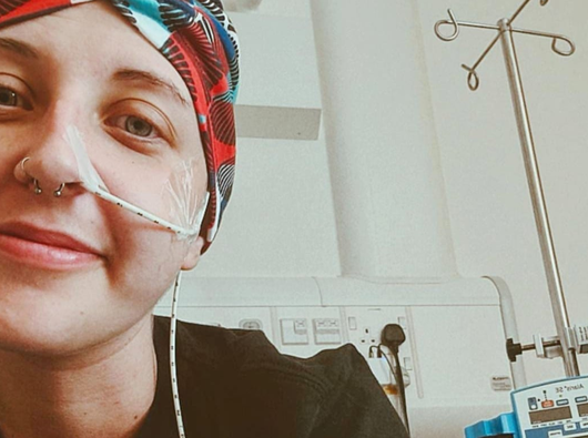 A young woman in hospital bed.