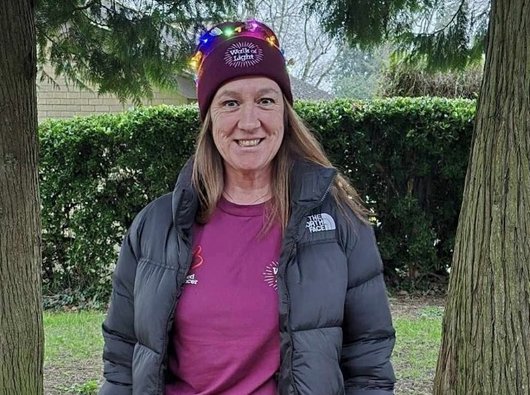 Women smiling in hat to camera at night