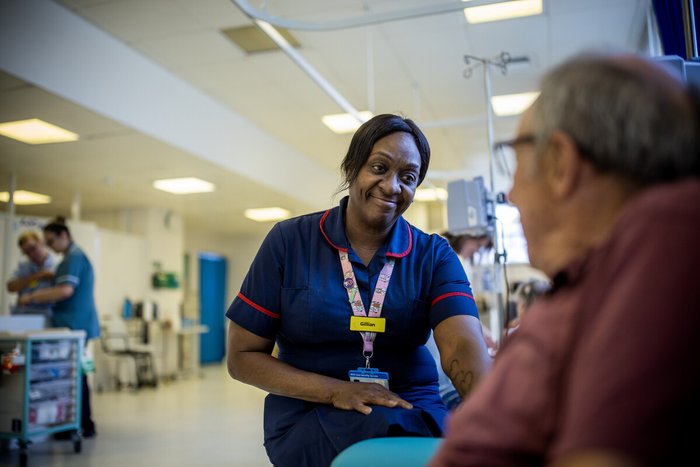 Nurse in day unit speaking to a patient