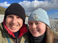 A man with his grandchild smiling.