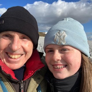 A man with his grandchild smiling.