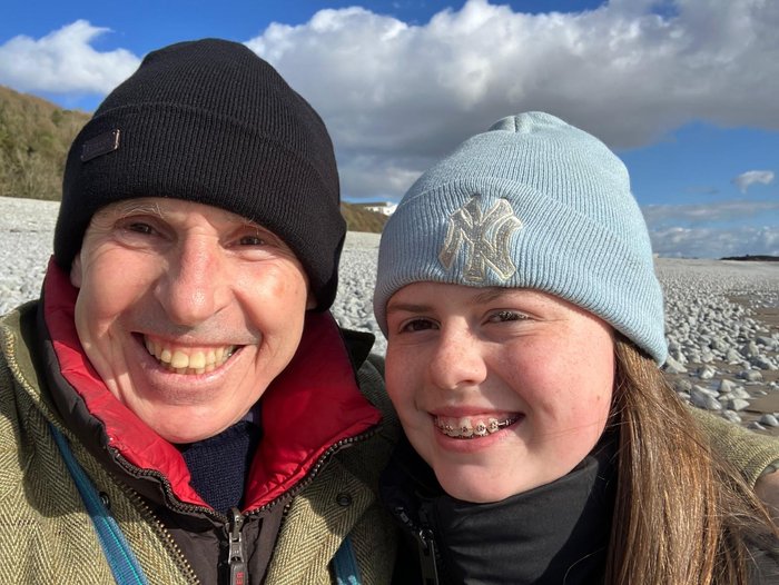 A man with his grandchild smiling.