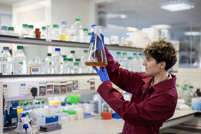 A researcher holding a test tube.