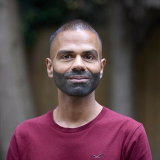 Headshot of Sunny, a person affected by blood cancer, smiling at the camera.