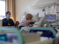 Nurse with a person in a hopsital bed