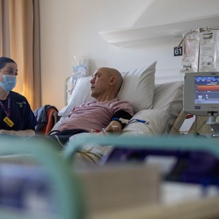 Nurse with a person in a hopsital bed