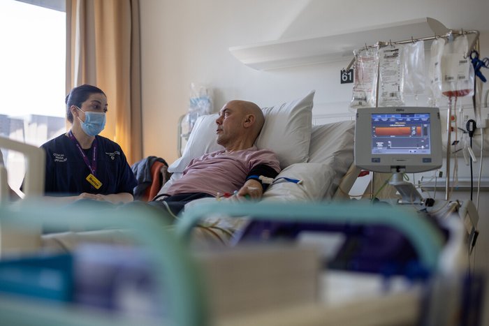 Nurse with a person in a hopsital bed