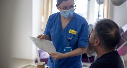 Nurse with a patient in bed, explaining some information