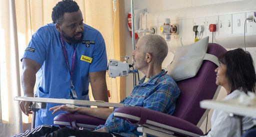 Healthcare professional with a person with blood cancer