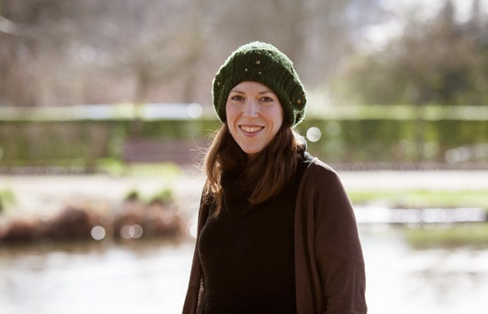 Katie, who was diagnosed with chronic myeloid leukaemia (CML), standing outside wearing a hat smiling at the camera with a blurred background.