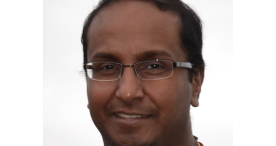 A man, wearing glasses, in a head shot.