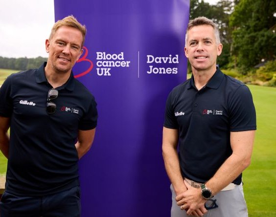 Simon Thomas and David Jones stood in front of a Blood Cancer UK banner.