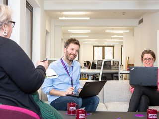 Blood Cancer UK staff looking happy in an informal meeting.