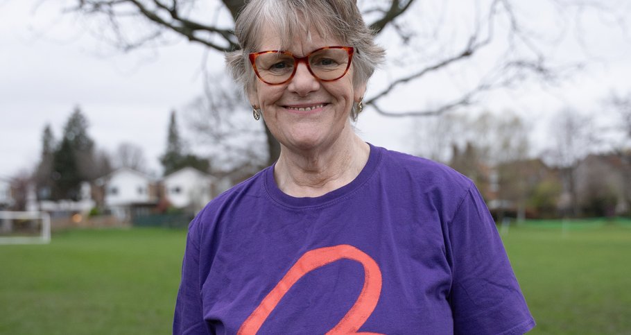 Female wearing purple Blood Cancer UK t-shirt smiling for the camera