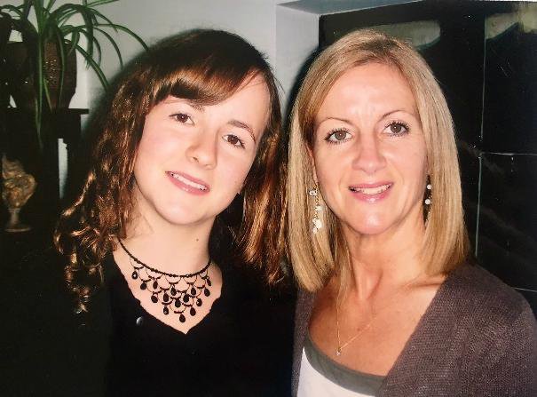 Two women - Amy and her mum - pose for a photograph.