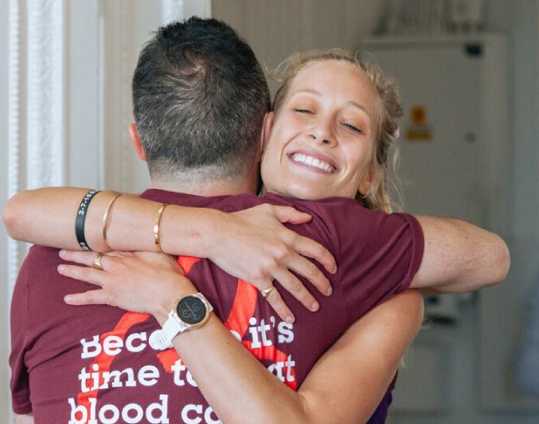 Two Blood Cancer supporters hug at the London marathon race reception