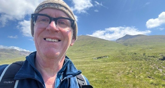 Colin takes a selfie on a munro
