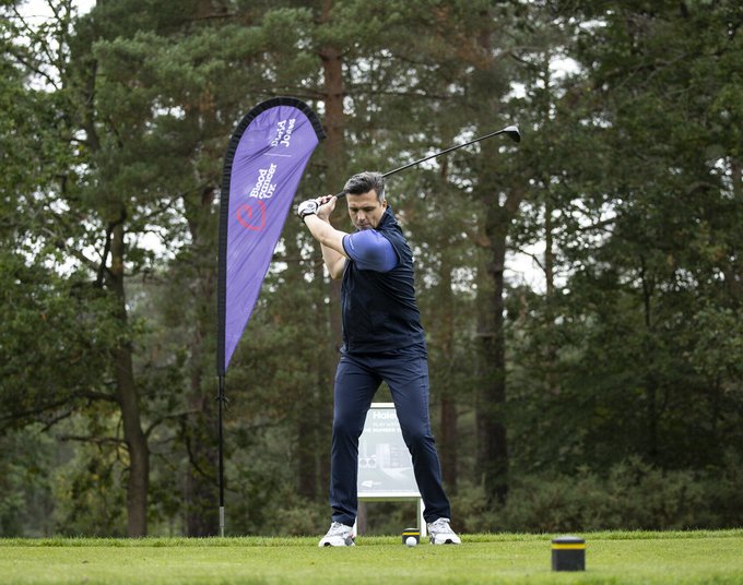 A golfer is about to tee-off