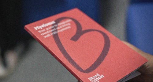 A close up of a red booklet about blood cancer. There is the Blood Cancer UK heart logo on the cover.