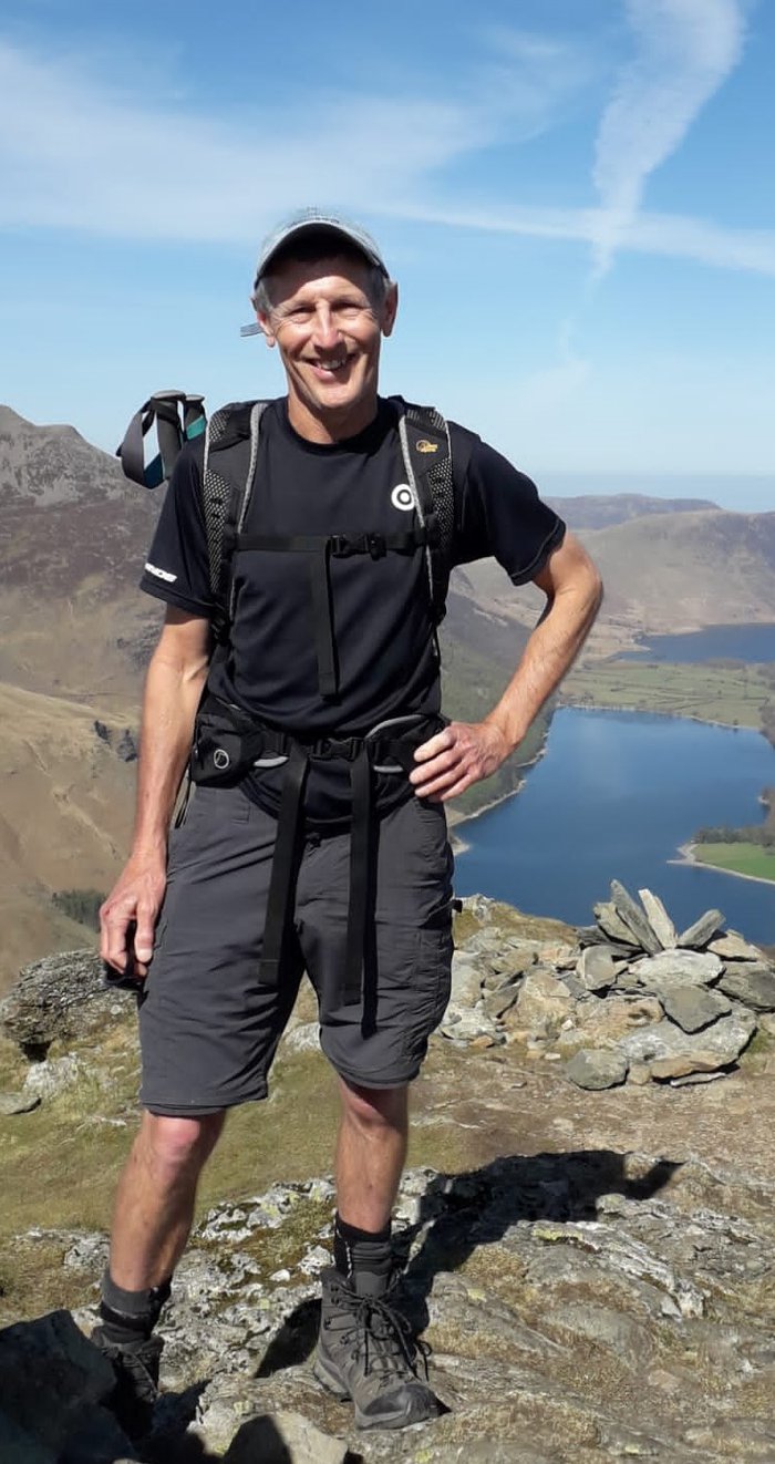 Photo of James smiling whilst outside on a walk