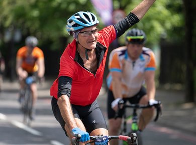man cycling in a red top