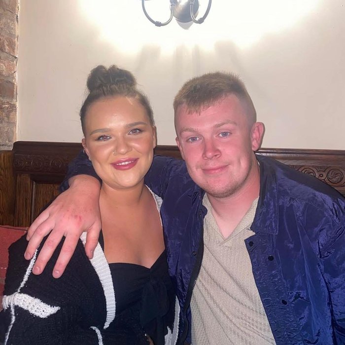 Man and wife arms around shoulders