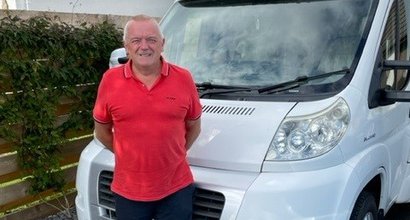 Craig, who is living with myeloma, standing in front of his motor home
